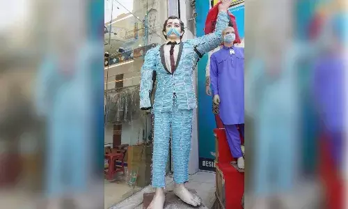 10-ft mannequin in suit made of 250 masks is here to remind you to wear masks