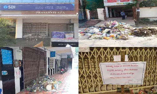 Sanitation workers dump garbage in front of banks for delaying loan disbursement in Andhra