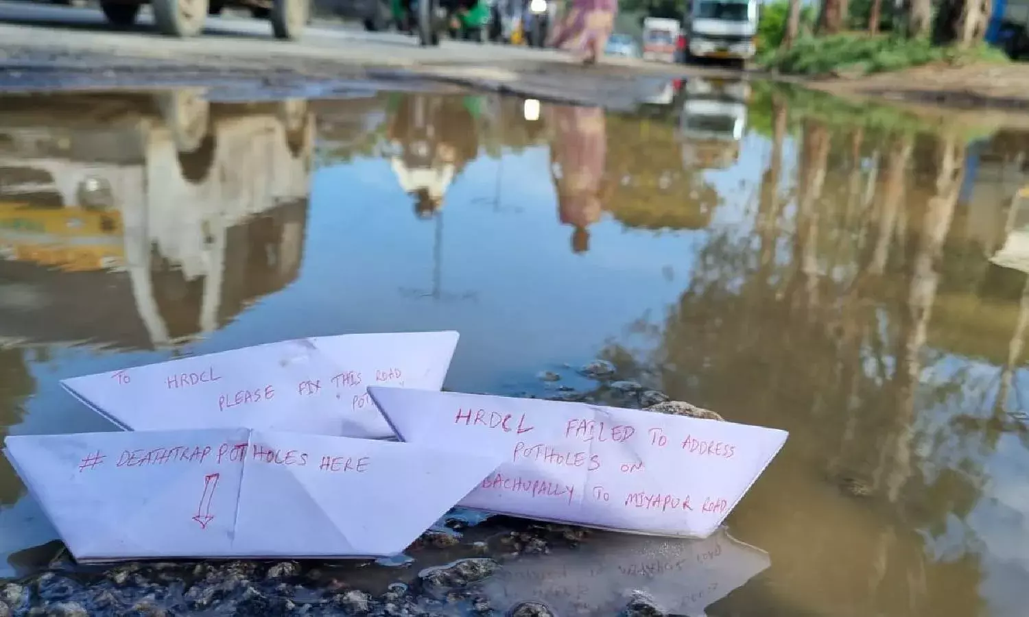 Deathtrap: Commuters of Bachupally-Miyapur road float paper boats, protests against potholes