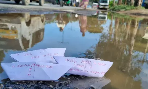 Deathtrap: Commuters of Bachupally-Miyapur road float paper boats, protests against potholes