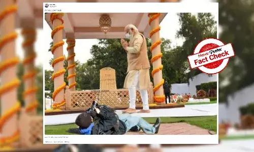 Morphed image shows a photographer lying on ground to take Modis photo