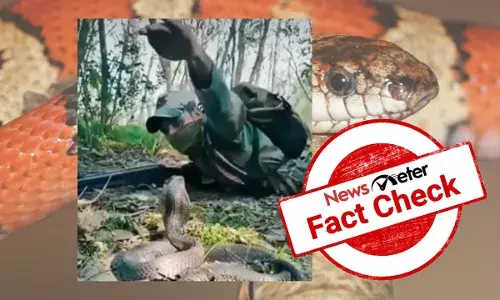 Man in uniform catching cobra is not an Indian army soldier