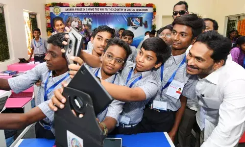 AP first state to get digital classrooms, Jagan sits in the classroom with students.