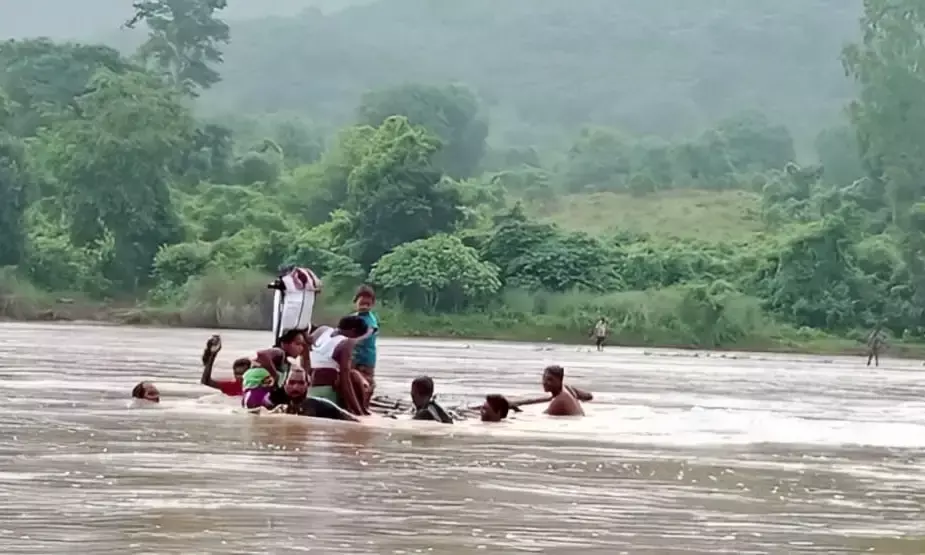 With two sick kids, tribals cross overflowing Nagavali in makeshift boat in Andhra